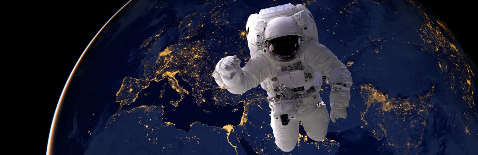 Astronaut spacewalk at night from the dark side of the earth